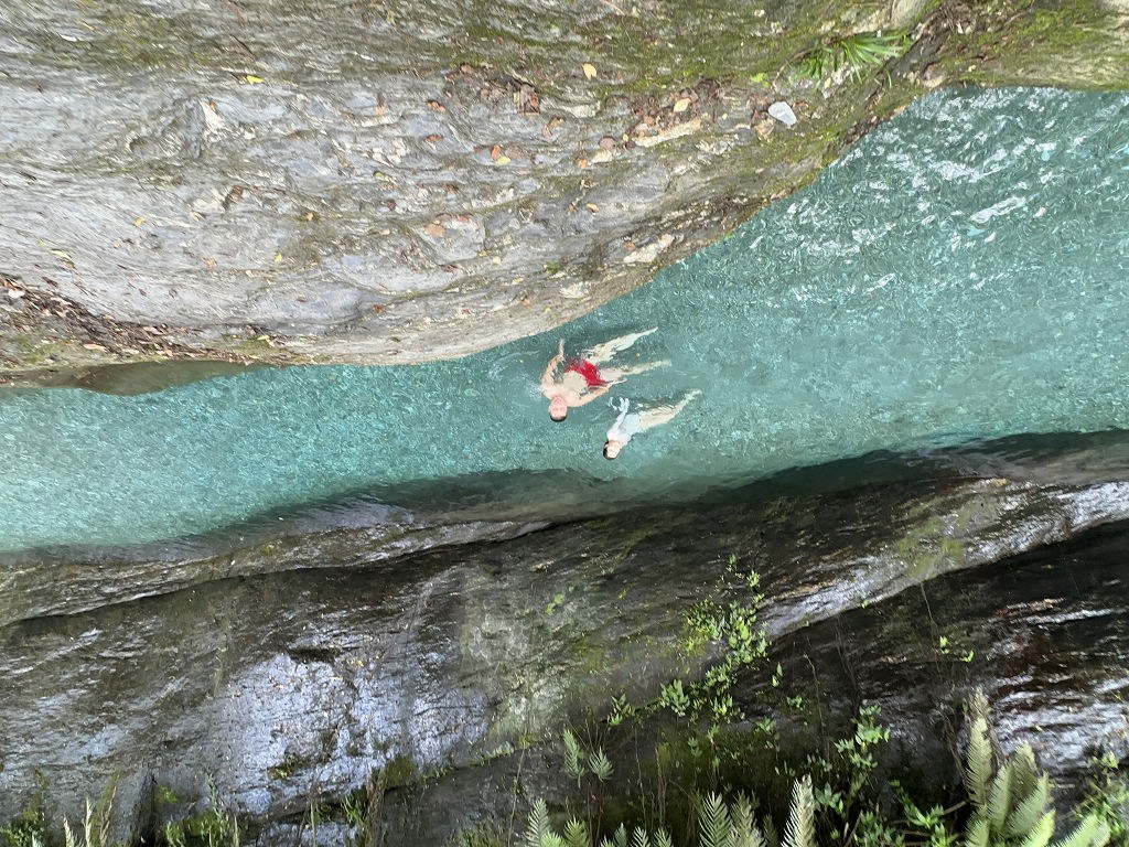 空拍兩人仰躺漂浮溪水中